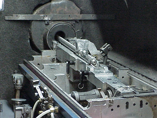 With the barreled action assembled, it then goes to proof testing.  Note that the trigger assembly is not installed at this point, as the fixture is fitted with a pneumatic trigger mechanism to fire the proof loads.