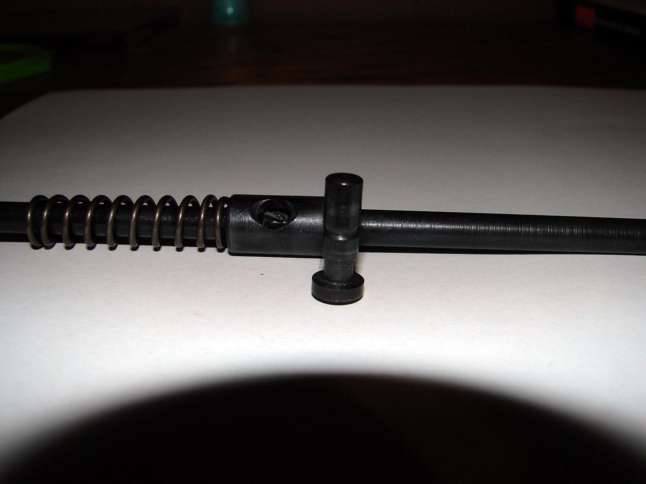 This photo shows the groove machined into the cocking pin to accept and use the tail of the firing pin spring for retention.