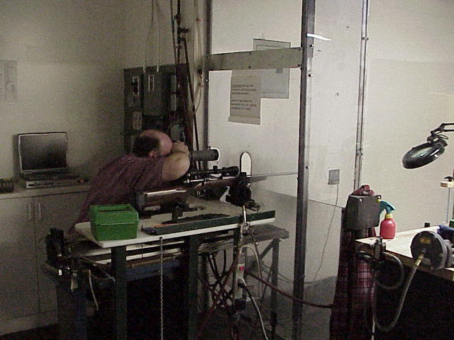 One of the Savage engineers putting Fred's new rifle to use on their indoor range.